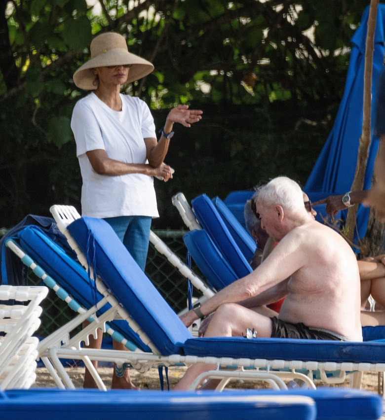 *EXCLUSIVE* The British Actor Michael Caine gets a little help from his female friends as he enjoys his Easter Break with his wife Shakira out on the beaches of Barbados.