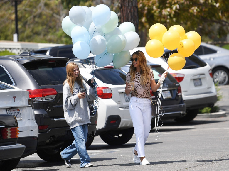 EXCLUSIVE: Kevin Costner's wife Christine Baumgartner gets two huge bouquets of birthday balloons for their son's 16th birthday while out with Grace Saturday
