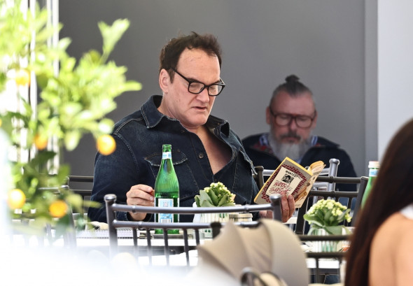 *EXCLUSIVE* The American Film Director Quentin Tarantino enjoys a cigar on the terrace of the Carlton Hotel during the 76th Cannes Film Festival.