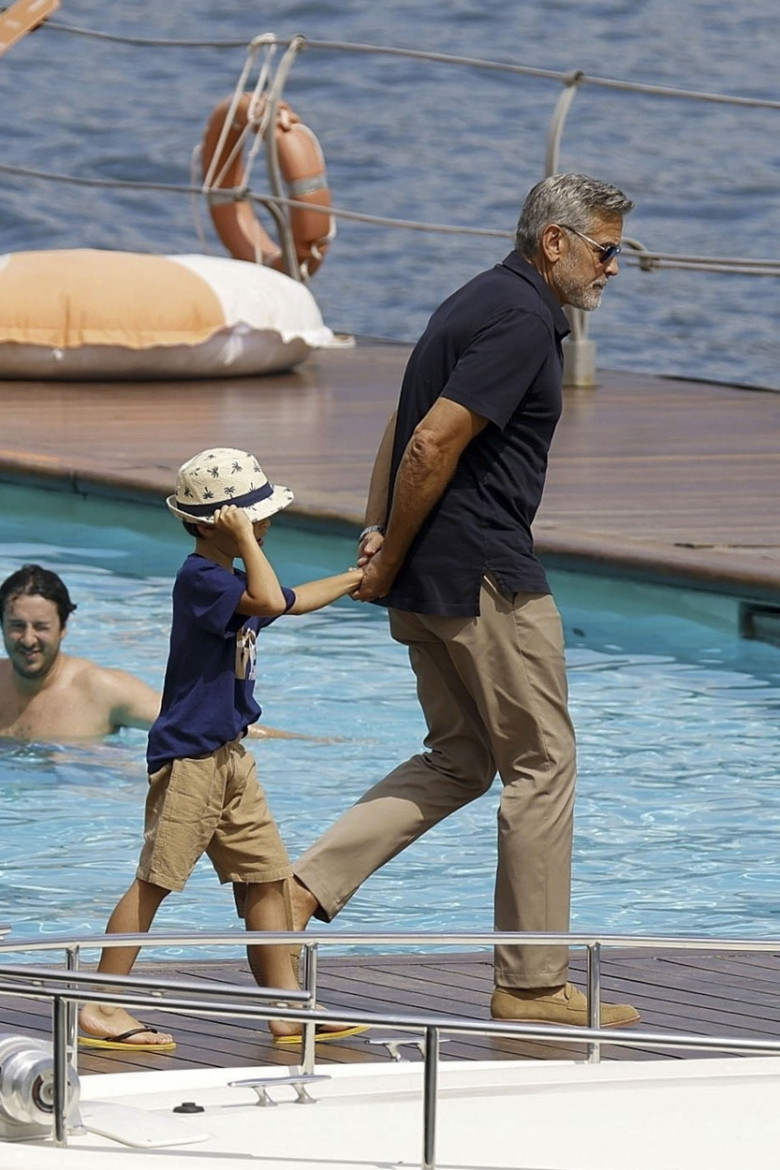 George Clooney and Amal Clooney, accompanied by their sleepy kids Ella and Alexander, embark on a picturesque boat trip in Como