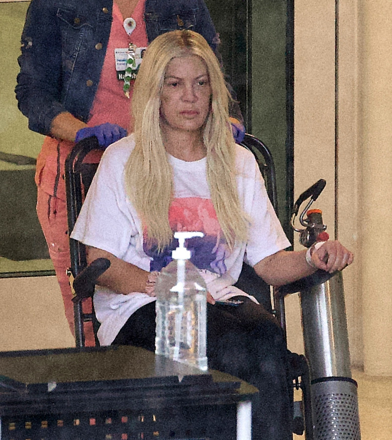 EXCLUSIVE: **PREMIUM EXCLUSIVE RATES APPLY** Bruised And Battered Tori Spelling Leaves The Hospital In A Wheelchair With Visible Marks On Her Face And Arms After Mystery Accident