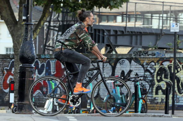 EXCLUSIVE: Russell Brand is seen on riding his bike in North London
