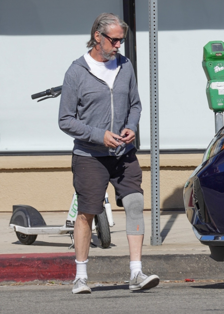 Alan Ruck is seen for the first time since crashing his car, visiting a liquor store in LA