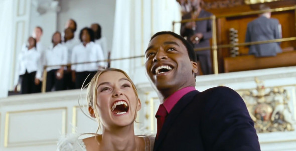 UK. Chiwetel Ejiofor, Keira Knightley in a scene from the ©Universal Pictures movie : Love Actually (2003). Plot: Follows the lives of eight very different couples in dealing with their love lives in various loosely interrelated tales all set during a fr