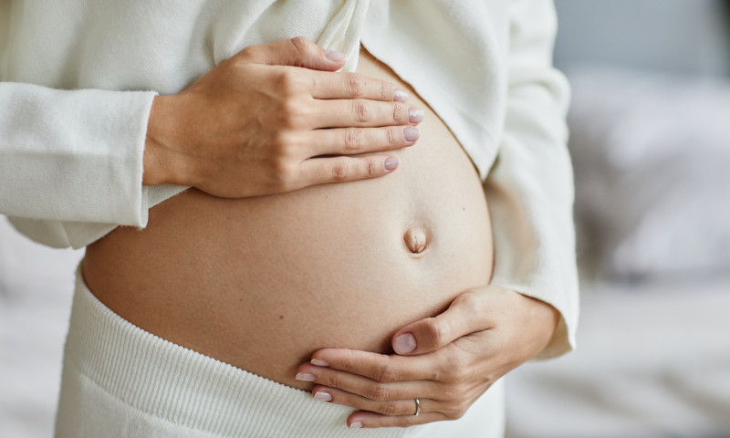 Close-up,Of,Young,Pregnant,Woman,Touching,Her,Belly,And,Caring