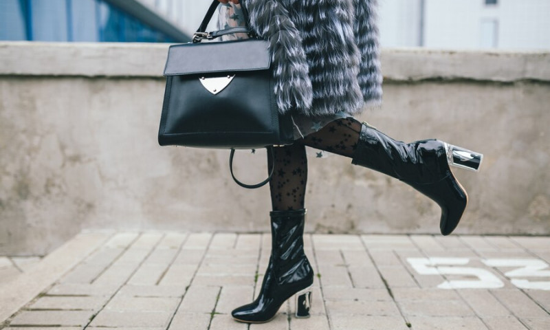close-up-accessories-details-stylish-woman-walking-city-warm-fur-coat-winter-season-cold-weather-holding-leather-handbag-legs-boots-footwear-street-fashion-trend_285396-4720