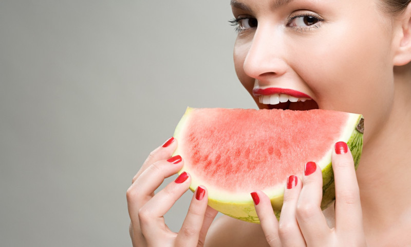Young woman eating watermelon