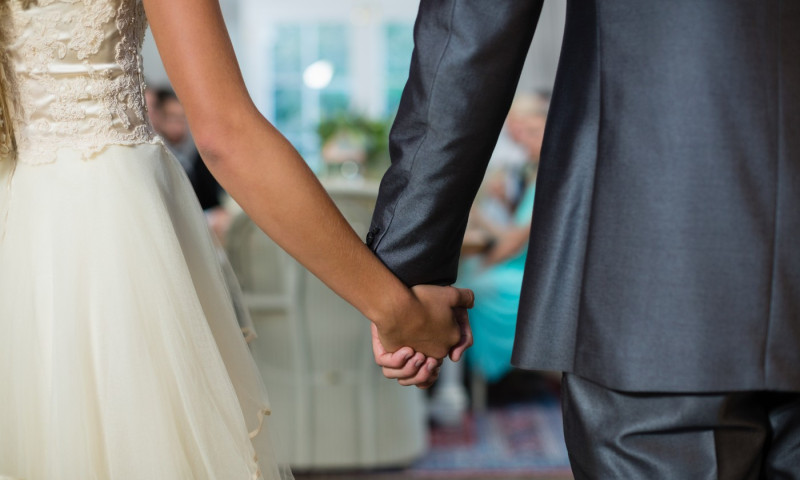 Wedding couple holding hands