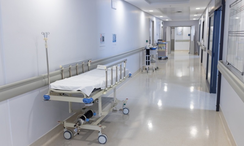 General view of corridor with beds and medical equipment at hospital