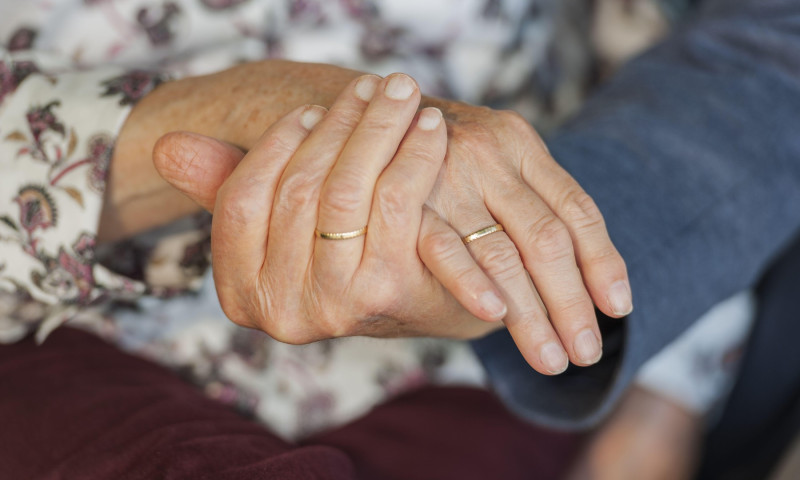 Hands of an 80 year old married couple