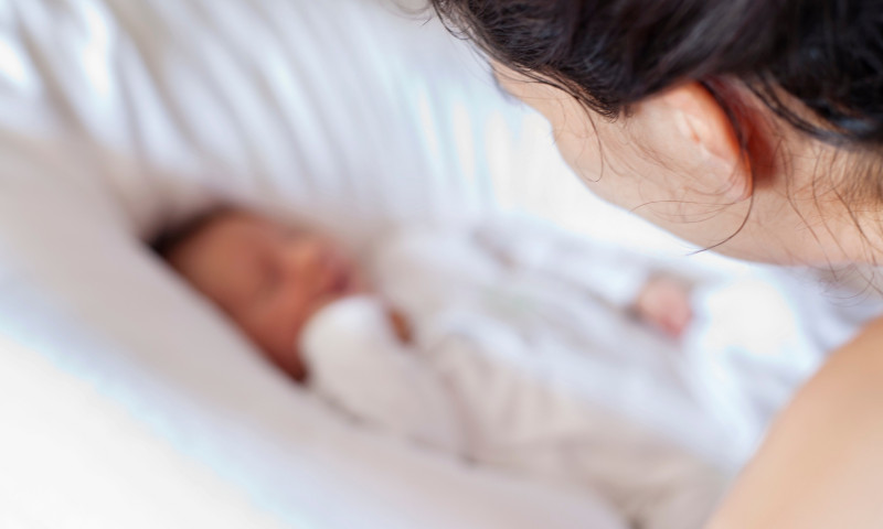 Mother watching over newborn baby
