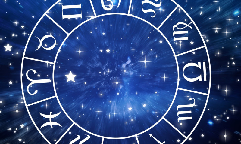 Composition of white zodiac star sign wheel over stars on blue background