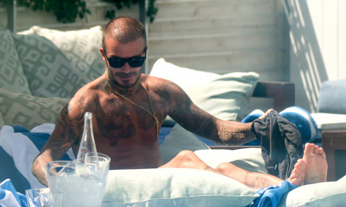 David Beckham is a Dirty Boy as he celebrates launch of football club by sunbathing and munching burgers in Miami