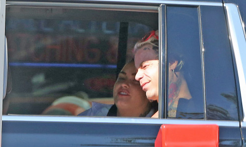 EXCLUSIVE: * PREMIUM RATES* Demi Lovato giggles in the back seat of a SUV with Bella Thorns Ex Mod Sun, The pair stopped at In-and-Out before heading to the market