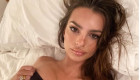 Model Emily Ratajkowski shows off her baby bump in a black cut-out dress with red boots in New York City