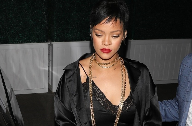 *EXCLUSIVE* Rihanna puts on a sultry display in black silk while leaving Delilah nightclub with friends!