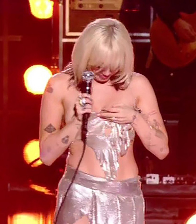 Miley Cyrus has a major wardrobe malfunction and almost exposes her boob as she performs on stage at her NBC special Miley Cyrus' New Year's Eve Party
