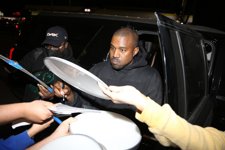 Kanye West and Julia Fox share a kiss as they leave dinner