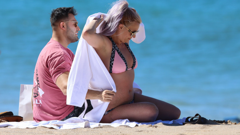 PREMIUM EXCLUSIVE: Britney Spears is seen wearing a pink and black bikini before covering up in a bath robe while on vacation with her boyfriend Sam Asghari