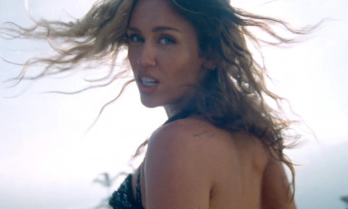 Miley Cyrus steams up the screen as she goes topless in new music video for latest single – the breakup ballad Jaded.