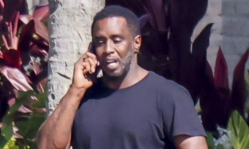*PREMIUM-EXCLUSIVE* Sean 'Diddy' Combs appears downcast as he  relaxes by the water in Miami with  woman believed to be his longtime assisitant after settling the rape and abuse case with Cassie