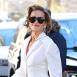 Rita Ora wears a white pant suit and white mules to The View in New York City