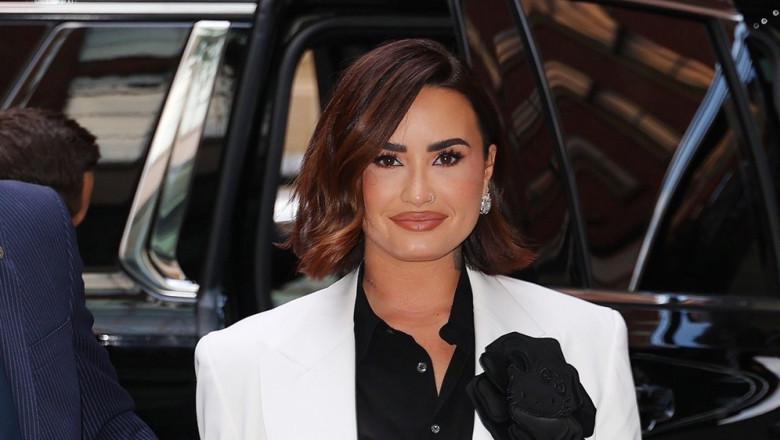 Demi Lovato stuns at Vogue dinner party with chic black and white outfit and Hello Kitty flower