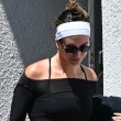 Hailey Bieber leaves the gym looking fit in form-fitting attire, complemented by a pop of color in her SKYLRK sandals