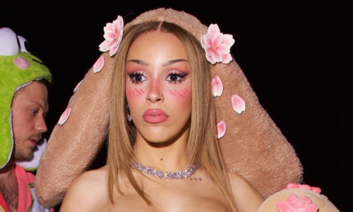 Doja Cat wears a bold plush bunny costume to her doll-themed birthday party