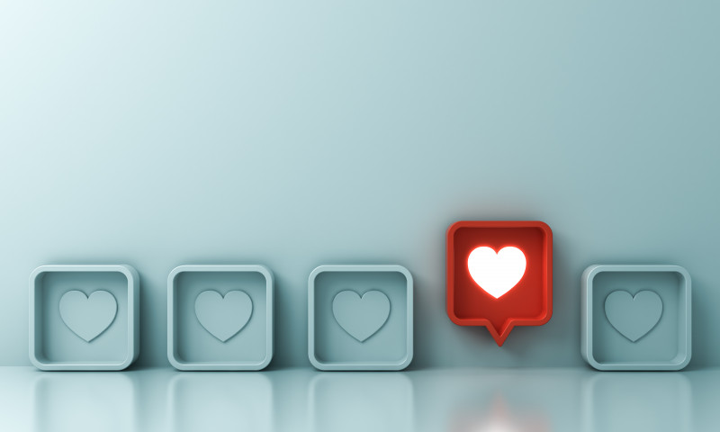 One red social media notification love like heart pin icon pop up from others on light green pastel color wall background Stand out from the crowd and different creative idea concepts