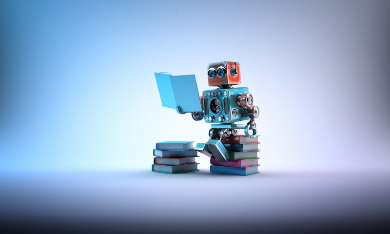 Robot sitting on a bunch of books. Contains clipping path