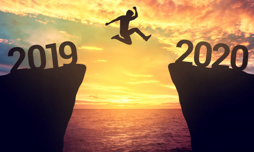 Businessman jump between 2019 and 2020 years.