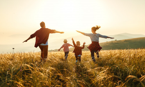 Happy family: mother, father, children son and daughter on sunset