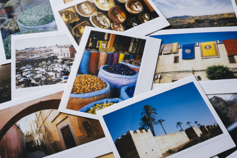 Collection of instant travel holiday photos on a table