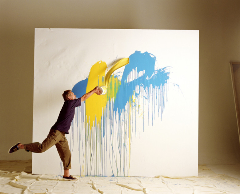 ARTIST THROWING PAINT AT CANVAS