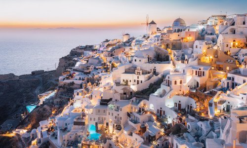 Oia, Santorini Island, Cyclades, Greece.  cityscape, Houses and churches with bell, sea on background