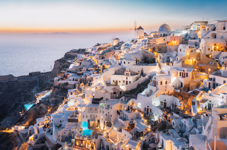 Oia, Santorini Island, Cyclades, Greece.  cityscape, Houses and churches with bell, sea on background