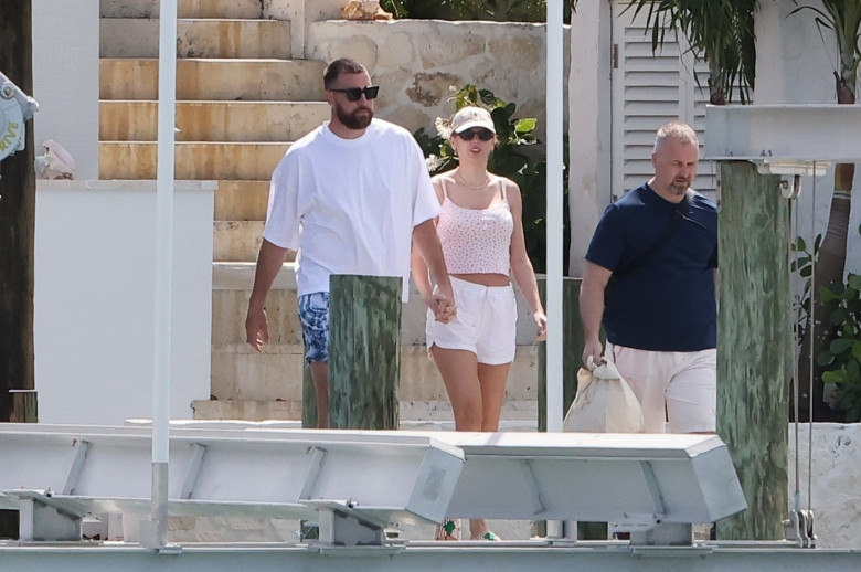 *PREMIUM-EXCLUSIVE* Taylor Swift and Travis Kelce hold hands as she follows him down the stairs to the boat dock in on romantic Bahamas getaway!