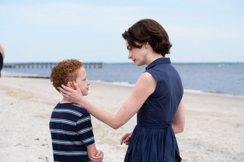 USA. Anne Hathaway and Eamon Patrick O'Connell in a scene from (C)Neon new film: Mothers' Instinct (2024). Plot: Alice and Celine live a traditional lifestyle with successful husbands and sons of the same age. Life's perfect harmony is suddenly shattered