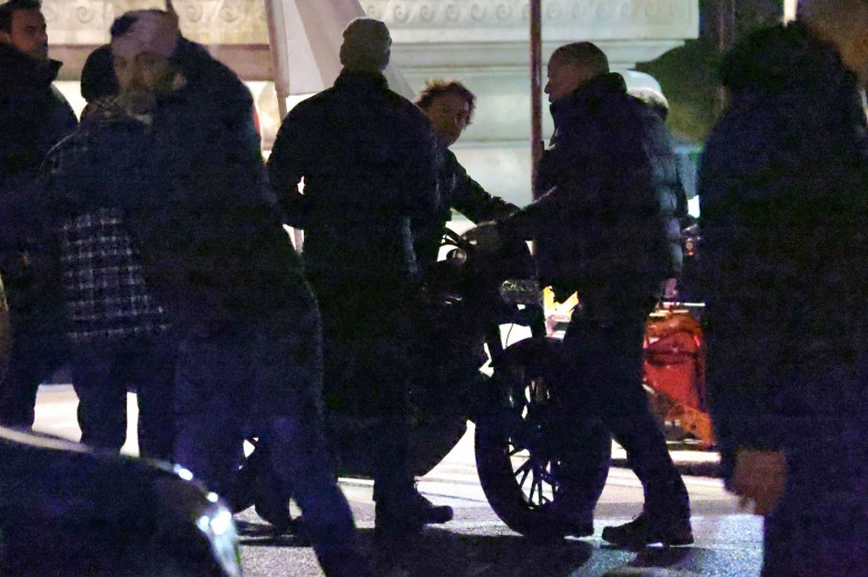 Tom Cruise rides a motorcycle on the Bir Hakeim Bridge while filming the upcoming Mission Impossible in Paris