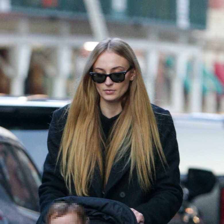 Sophie Turner takes a stroll with her two young daughters in NYC.