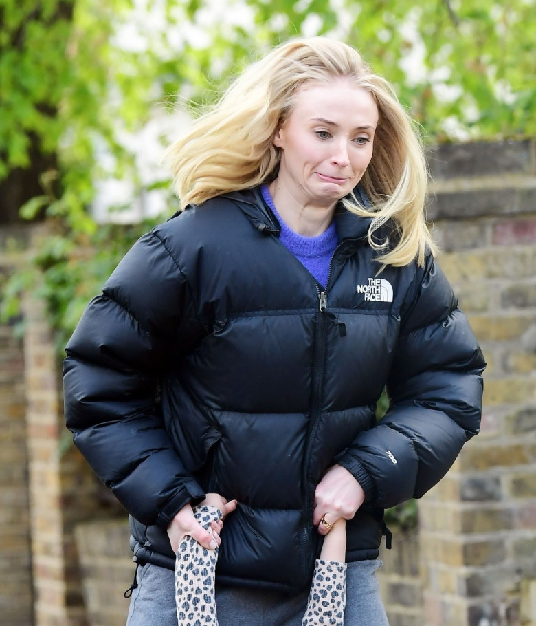 *PREMIUM-EXCLUSIVE* MUST CALL FOR PRICING BEFORE USAGE  - Game of Thrones English actress Sophie Turner rocks a large gold band as she looks in great mood as she's pictured having a great time with her daughter and friends in Sunny London.*PICTURES TAKEN