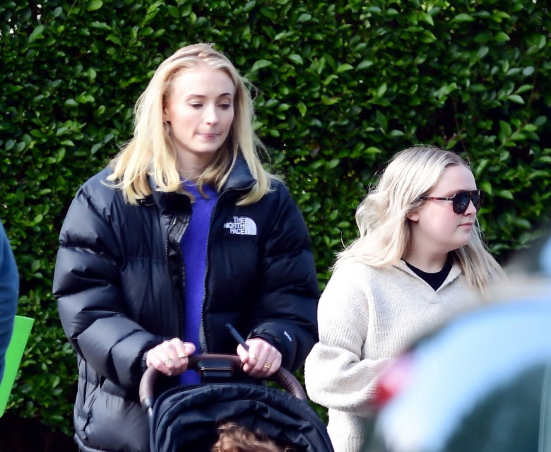 *PREMIUM-EXCLUSIVE* MUST CALL FOR PRICING BEFORE USAGE  - Game of Thrones English actress Sophie Turner rocks a large gold band as she looks in great mood as she's pictured having a great time with her daughter and friends in Sunny London.*PICTURES TAKEN