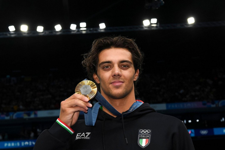 Thomas Ceccon of Italy attends the medal ceremony of the 100m Backstroke Men Final during the Paris 2024 Olympic Games at La Defense Arena in Paris (France), July 29, 2024. Thomas Ceccon placed first winning the gold medal.