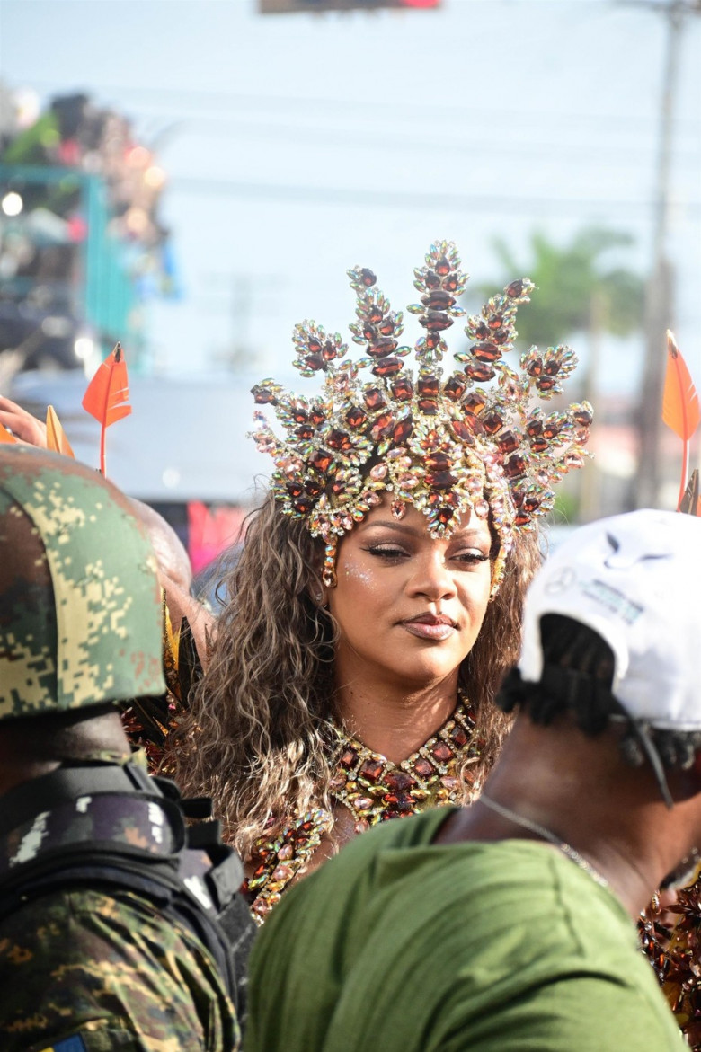 *EXCLUSIVE* Singer Rihanna Stuns at Carnival Festival In Barbados showcasing her 2024 outfit in a bejeweled bikini as she poses with police and fans