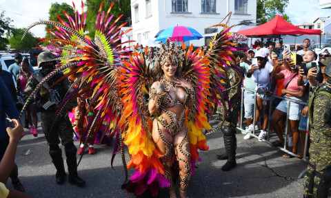 *EXCLUSIVE* Singer Rihanna Stuns at Carnival Festival In Barbados showcasing her 2024 outfit in a bejeweled bikini as she poses with police and fans