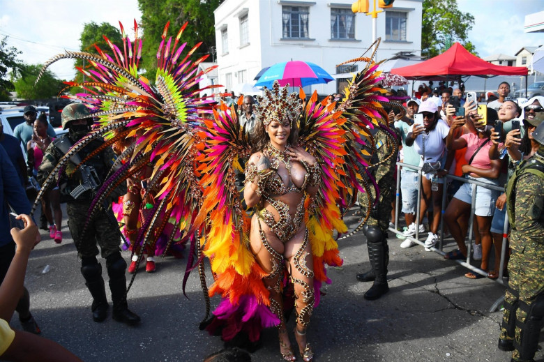 *EXCLUSIVE* Singer Rihanna Stuns at Carnival Festival In Barbados showcasing her 2024 outfit in a bejeweled bikini as she poses with police and fans