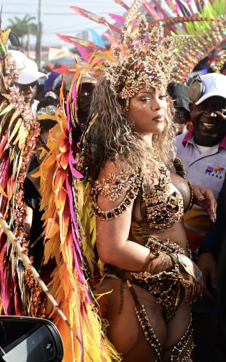 *EXCLUSIVE* Singer Rihanna Stuns at Carnival Festival In Barbados showcasing her 2024 outfit in a bejeweled bikini as she poses with police and fans