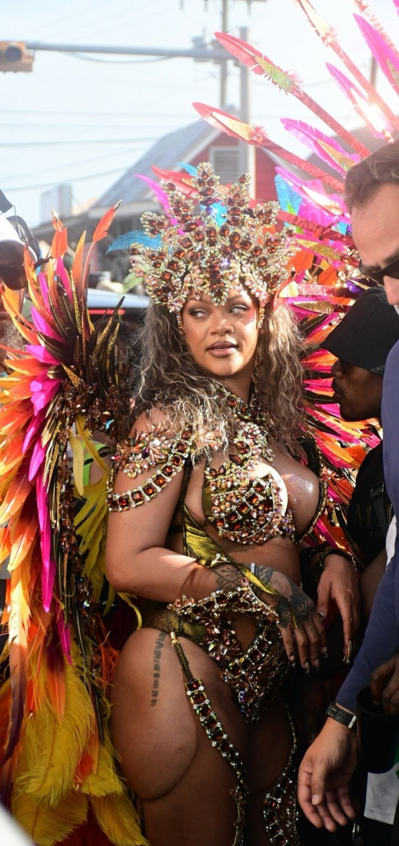 *EXCLUSIVE* Singer Rihanna Stuns at Carnival Festival In Barbados showcasing her 2024 outfit in a bejeweled bikini as she poses with police and fans