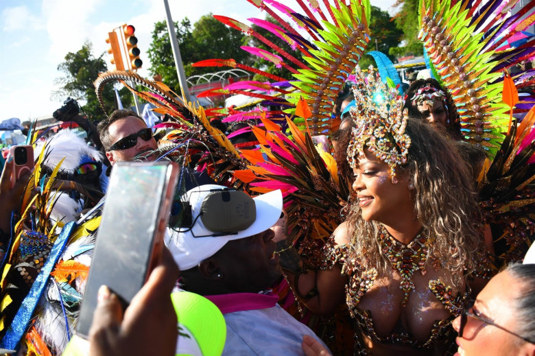 *EXCLUSIVE* Singer Rihanna Stuns at Carnival Festival In Barbados showcasing her 2024 outfit in a bejeweled bikini as she poses with police and fans